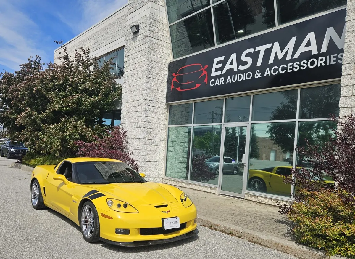 Eastman Car Audio & Accessories storefront on Bryne Drive in Barrie with a yellow Corvette parked out front