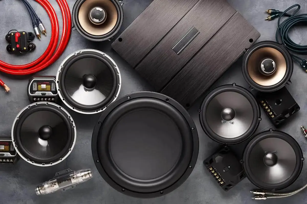 Car audio components laid out: subwoofers, component speakers, an amplifier and wiring